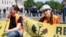 FILE - An activist of the Last Generation group sits on a street during a protest for climate protection in Vienna, Austria, May 4, 2024. Six members of Last Generation disrupted flights at the Munich, Germany, airport on May 18, 2024.
