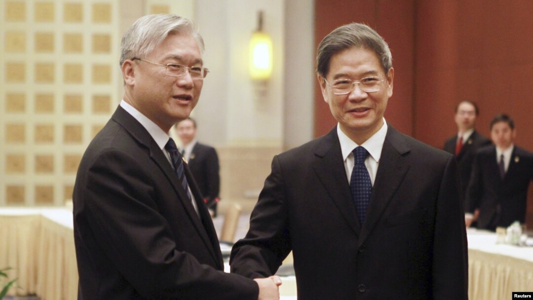 Ông Zhang Zhijun (phải), giám đốc Văn phòng Đài Loan Sự vụ của Trung Quốc bắt tay ông Andrew Hsia, Chủ tịch Hội đồng Hoa lục Sự vụ của Đài Loan tại Quảng Châu, tỉnh Quảng Đông ngày 14/10/2015.