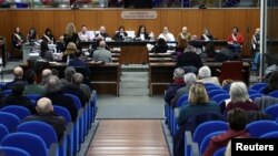 People sit in the courthouse during the trial of four senior members of Egyptian security services over their suspected role in the disappearance and murder of Italian student Giulio Regeni in Cairo in 2016. The trial is in Rome, Italy, on February 20, 2024.