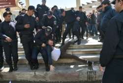 FILE - Police detain a protester participating in a rally organized by journalists against alleged censorship of coverage of protests against a fifth term for then-President Abdelaziz Bouteflika, in Algiers, Algeria, Feb. 28, 2019.