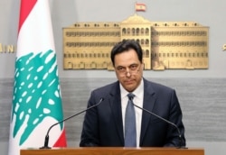 In this photo released by the Lebanese Government, Lebanese Prime Minister Hassan Diab, gives a speech at the Government House in Beirut, March. 7, 2020.