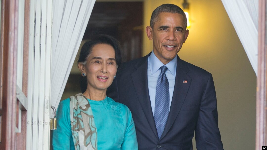 FILE - President Barack Obama walks out with Myanmar's Aung San Suu Kyi at her home before the start of their joint news conference in Yangon, Myanmar. 