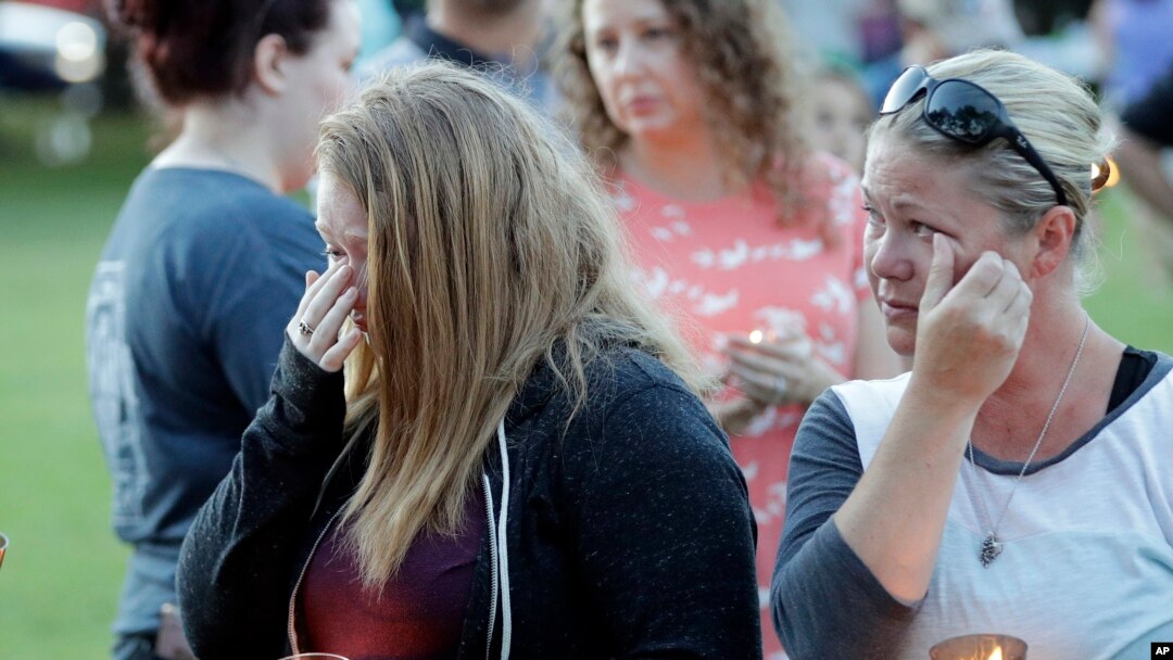 Santa Fe High School freshman Kylie Trochesset, left, and her mother, Ashlee, wipe away tears during a prayer vigil following a shooting at Santa Fe High School in Santa Fe, Texas, May 18, 2018.