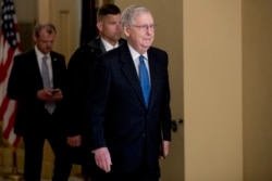 Senate Majority Leader Mitch McConnell of Ky. walks to the Senate Chamber on Capitol Hill in Washington, March 23, 2020, as the Senate is working to pass a coronavirus relief bill.