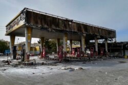 FILE - This photo released by the Iranian Students' News Agency, ISNA, shows a gas station that was burned during protests that followed authorities' decision to raise gasoline prices, in Tehran, Iran, Nov. 17, 2019.