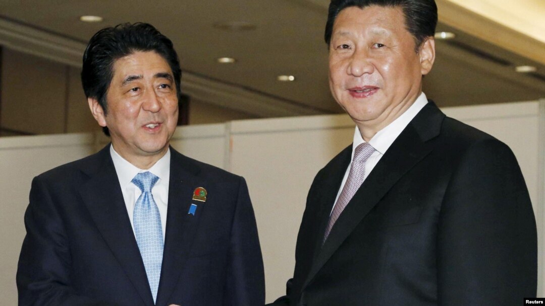 Japan's Prime Minister Shinzo Abe (L) shakes hands with China's President Xi Jinping at the start of their bilateral meeting on the side lines of the Asian-African Conference in Jakarta, in this photo released by Kyodo, April 22, 2015. 