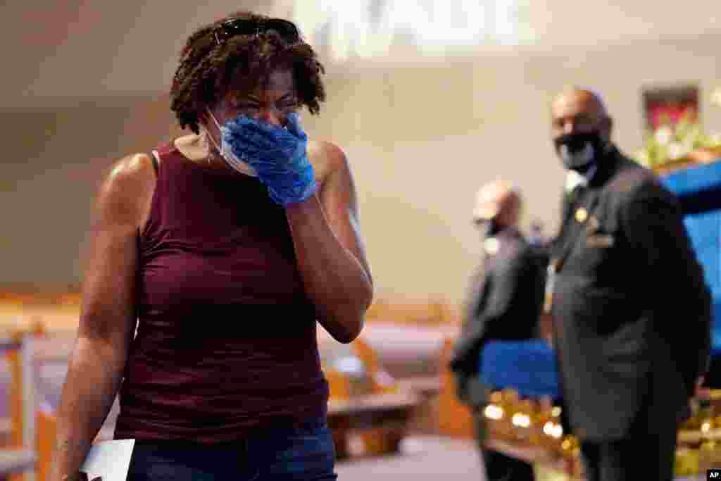 Mourner Charlene Thompson of Houston, passes by the casket of George Floyd during a public visitation for Floyd at the Fountain of Praise church in Houston, Texas.