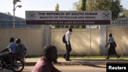 People pass by the Ministry of Petroleum and Mining in Juba, November 7, 2012. 