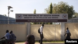 People pass by the Ministry of Petroleum and Mining in Juba, November 7, 2012. 