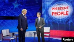 U.S. President Donald Trump takes the stage with ABC News chief anchor George Stephanopoulos for a town hall event in Philadelphia, Pennsylvania, Sept. 15, 2020. 