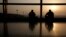 Men watch the runway on the morning of the final MH17 flight arriving at Kuala Lumpur International Airport. Malaysia Airlines retired flight number MH17 after its Amsterdam to Kuala Lumpur flight was shot down over the Ukraine.