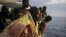 Migrants look out from the deck of the Spanish NGO ProActiva Open Arms vessel as they wait to reach the Italian coast on the Mediterranean Sea a day after being rescued off the Libyan coast, Sept. 7, 2017.