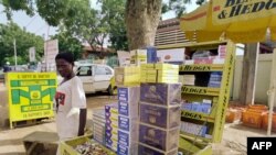 FILE - A young boy sells cigarettes in the streets of Ouagadougou.