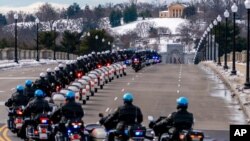 U.S. Capitol Police officers on motorcycles ride ahead of a hearse carrying the remains of U.S. Capitol Police officer Brian Sicknick as it makes its way to Arlington National Cemetery, Feb. 3, 2021.