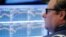 FILE - A trader works on the floor of the New York Stock Exchange shortly after the opening bell in New York, July 31, 2018. 