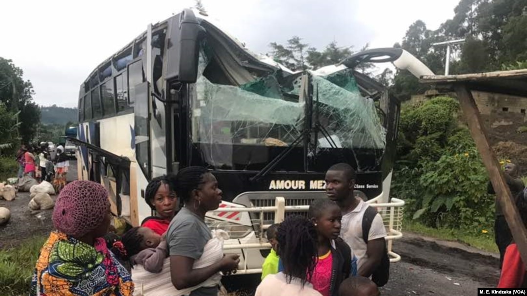 A bus attacked by armed separatist and its passengers are seen at Akum, a village 10 Kilometers from Bamenda, the capital of the Cameroon's English speaking northwest region, Sept. 9, 2018.
