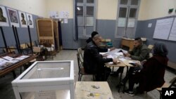 Polling station worker count ballots at a polling station Dec.12, 2019 in Algiers. 