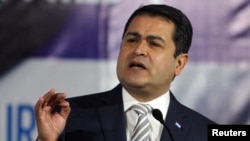 FILE - Honduran President Juan Orlando Hernandez addresses an audience in Tegucigalpa, July 16, 2014.