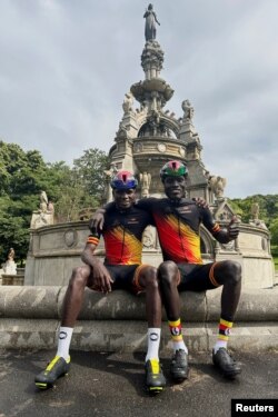 FILE - Ugandan cyclists Paul Lomuria and Lawrence Lorot pose for a photograph during the 2023 UCI Cycling World Championships in Glasgow, Scotland, Britain, August 7, 2023.