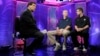 FILE - Greg Gumbel, left, watches as Connecticut head coach Jim Calhoun talks to Butler head coach Brad Stevens, right, prior to taping a television interview in Houston, Texas, April 3, 2011.