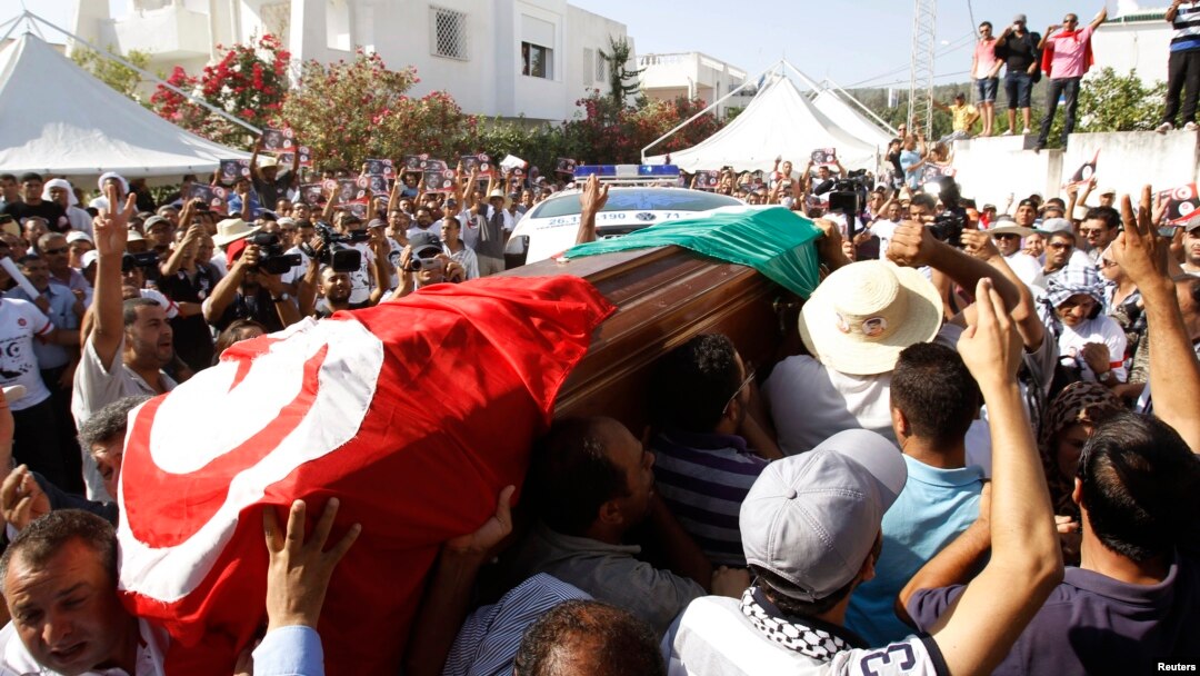 Mourners carried the coffin of slain opposition politician Mohamed Brahmi during part of his funeral procession in Tunis July 27, 2013.