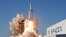 A SpaceX Falcon Heavy rocket, carrying the Arabsat 6A communications satellite, lifts off from the Kennedy...