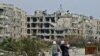 Residents of a suburban neighborhood on the edge of the northern Syrian city of Aleppo return to their homes to check the damage caused by fighting between regime forces and rebel fighters.