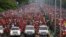 Thousands of people follow the funeral parade of Venezuela's late President Hugo Chavez in Caracas, March 15, 2013. 