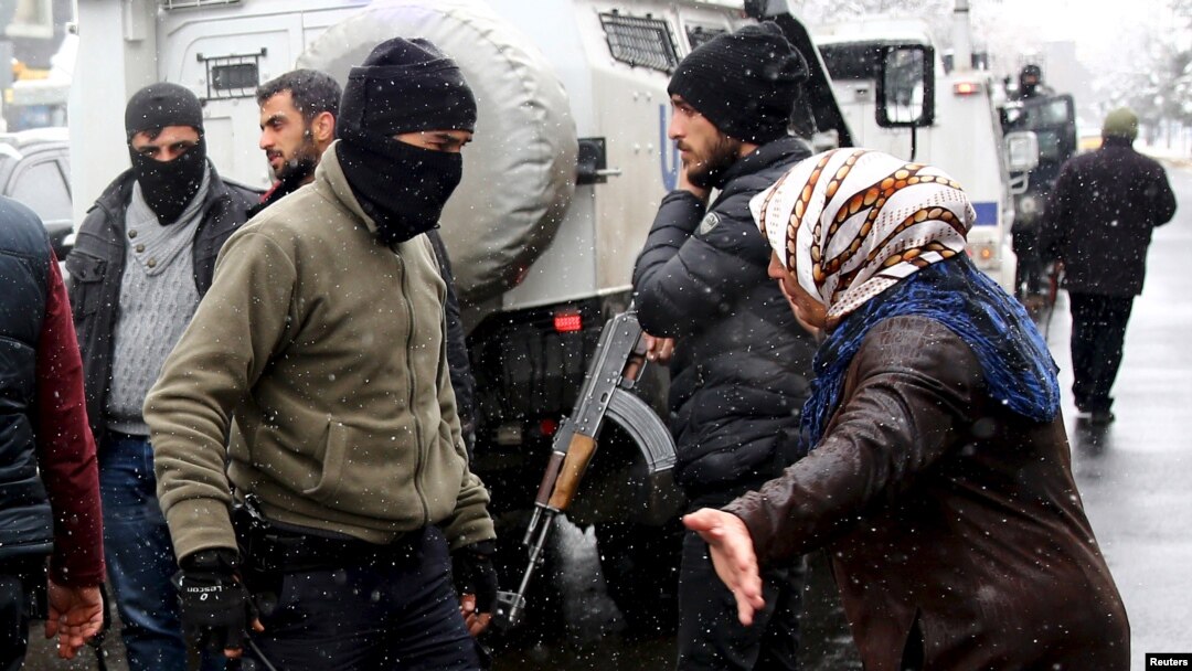 A Kurdish demonstrator argues with members of Turkish police special forces during a protest against the curfew in Sur district and security operations in the region, in the southeastern city of Diyarbakir, Turkey December 31, 2015.