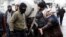 A Kurdish demonstrator argues with members of Turkish police special forces during a protest against the curfew in Sur district and security operations in the region, in the southeastern city of Diyarbakir, Turkey December 31, 2015.