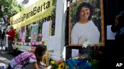 Mexico Honduras Environmentalist Killed: A woman places flowers on an altar set up in honor of Berta Caceres during a demonstration outside Honduras' embassy in Mexico City, Wednesday, June 15, 2016. 