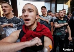 Activists of Ukrainian nationalist groups protest a court decision to release on bail Volodymyr Tsemakh, suspected of involvement in the downing of the Malaysia Airlines Flight MH17 in 2014, in Kyiv, Ukraine, Sept. 5, 2019.
