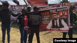 MDC youths carrying a banner with Ostallos Gift Siziba's image.