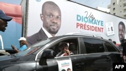 FILE —The coalition of anti-establishment candidate Bassirou Diomaye Faye supporters cheer in front of Senegalese opposition Ousmane Sonko's home in Keur Gorgui in Dakar on March 10, 2024 where the caravan set off for their 2024 presidential election campaign. 