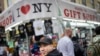 FILE - Karho Leung, 33, one of the founders of 12 Pell, a local barbershop, walks along Mott Street in Manhattan's Chinatown neighborhood, Jan. 25, 2024, in New York.