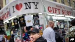 FILE - Karho Leung, 33, one of the founders of 12 Pell, a local barbershop, walks along Mott Street in Manhattan's Chinatown neighborhood, Jan. 25, 2024, in New York.