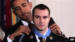 President Barack Obama presents the Medal of Honor to Staff Sgt. Salvatore Giunta, who rescued two members of his squad in October 2007 while fighting in the war in Afghanistan, 16 Nov 2010