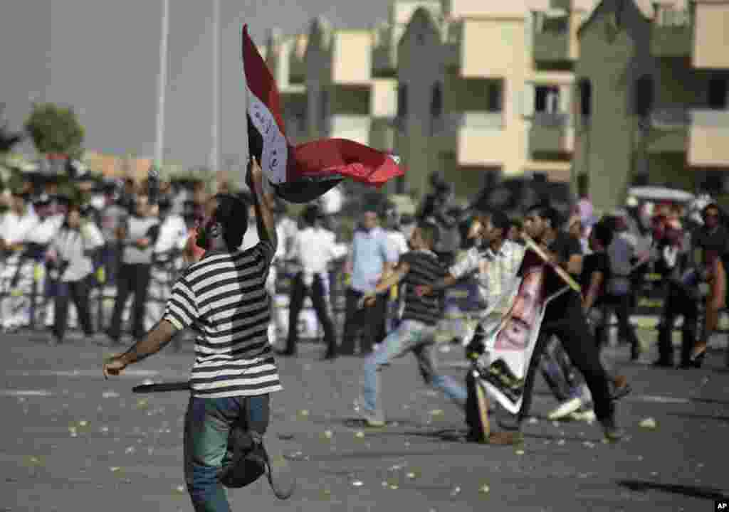 Anti-Mubarak protesters clashes with pro-Mubarak supporters outside the police academy in Cairo. (AP Image)