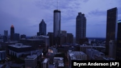 Clouds roll into downtown Atlanta on Wednesday, Aug. 11, 2021. (AP Photo/Brynn Anderson)