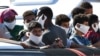 Migrants rescued by Italy's Coast Guard arrive in the harbor of the Italian Pelagie Island of Lampedusa on July 29, 2020. 