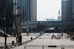 A man sits in a deserted shopping area in Changsha, Hunan province, China, as the country is hit by an outbreak of a new coronavirus, Jan. 29, 2020.