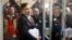 Former Georgian President Mikheil Saakashvili stands behind the glass and talks to reporters before the hearing in a court room in Kyiv, Ukraine, Dec. 11, 2017. 