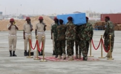 Members of a Somali military unit carry the body of the Mogadishu mayor Abdirahman Omar Osman for burial, in Mogadishu, Somalia, Aug. 4, 2019.