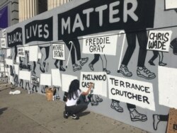 FILE - Murals appear throughout New York City in response to the death of George Floyd while in police custody in Minneapolis, June 10, 2020.