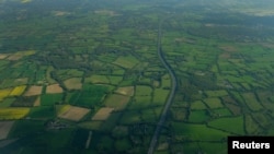 FILE - Farmers' fields are seen above Gatwick airport near London, Britain.