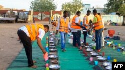 FILE—Volunteers arrange food on plates for internally displaced Muslim devotees breaking fast meals during the Islamic holy month of Ramadan in Gedaref on March 13, 2024.