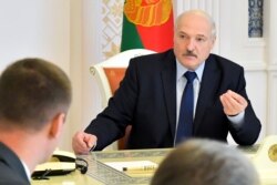 Belarusian President Alexander Lukashenko speaks at a meeting in Minsk, Belarus, Aug. 14, 2020.