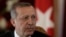 FILE - Turkish President Recep Tayyip Erdogan listens during a news conference in Riga, Oct. 23, 2014. 