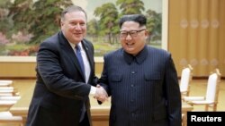 FILE - North Korean leader Kim Jong Un shakes hands with U.S. Secretary of State Mike Pompeo, May 9, 2018, released by North Korea's Korean Central News Agency in Pyongyang.