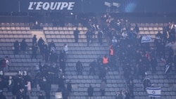 Petugas keamanan di dalam stadion bergerak ke arah para penonton yang membawa bendera Israel dalam pertandingan antara Prancis melawan Israel di Stade de France, Paris, pada 14 November 2024. (Foto: AFP/Franck Fife)